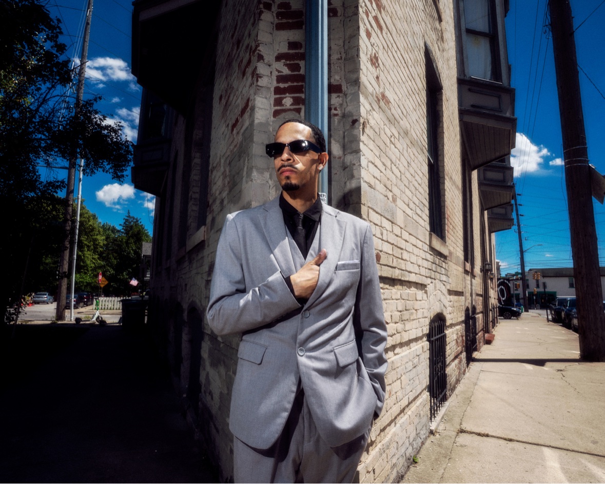 Grey suit against a brick building