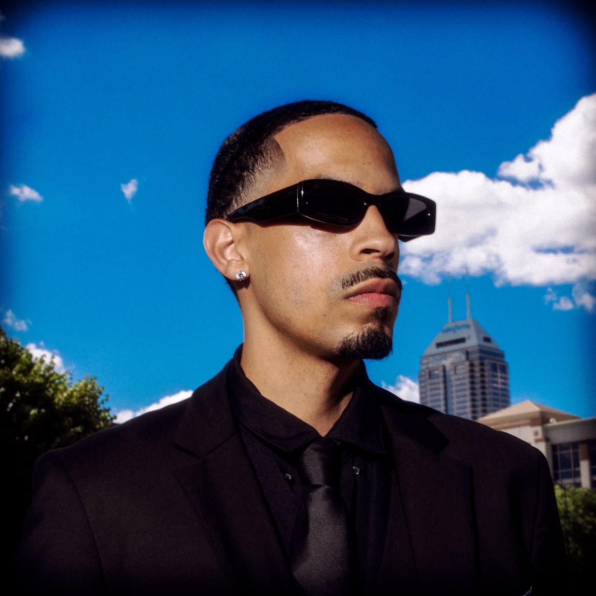 Black suit portrait against blue sky
