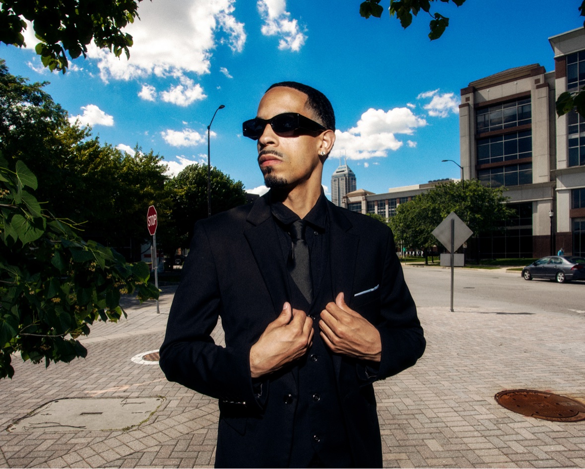 Black suit adjusting jacket on the street