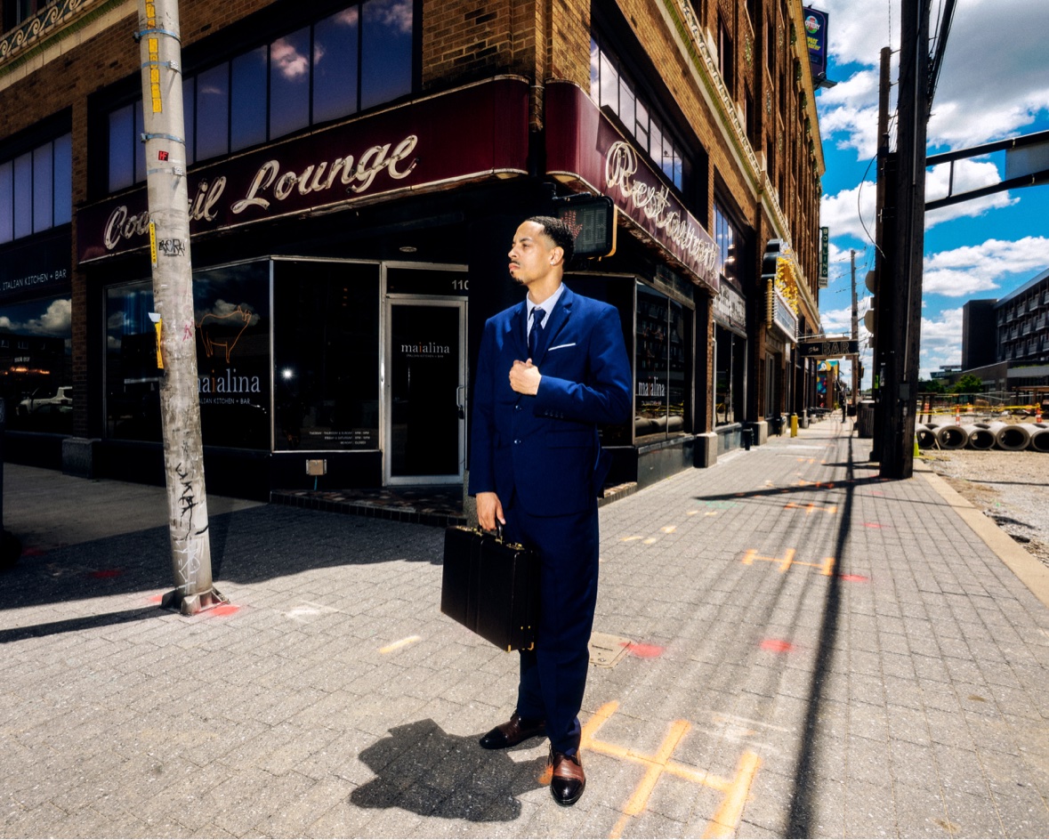 Navy suit with briefcase outside a cocktail lounge