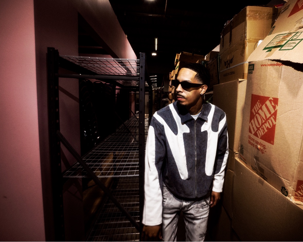 Black and white patterned jacket in a warehouse aisle